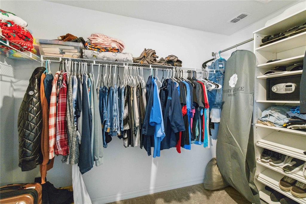 14339 Easy Goer Street Ruskin, FL 33573 - Photo 43 of 49 a view of walk in closet with clothes