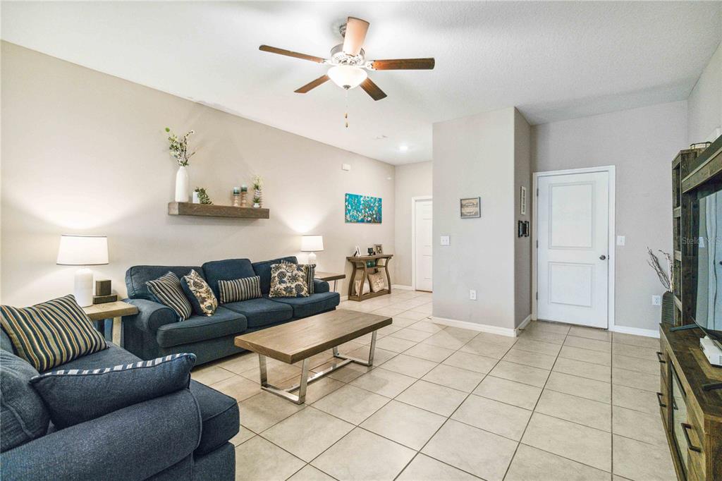 14339 Easy Goer Street Ruskin, FL 33573 - Photo 8 of 49 a living room with furniture and a flat screen tv