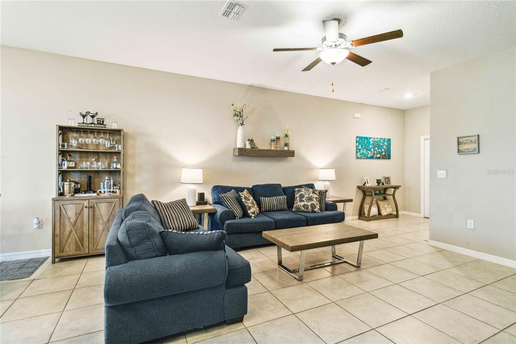 14339 Easy Goer Street Ruskin, FL 33573 - Photo 9 of 49 a living room with furniture and a ceiling fan