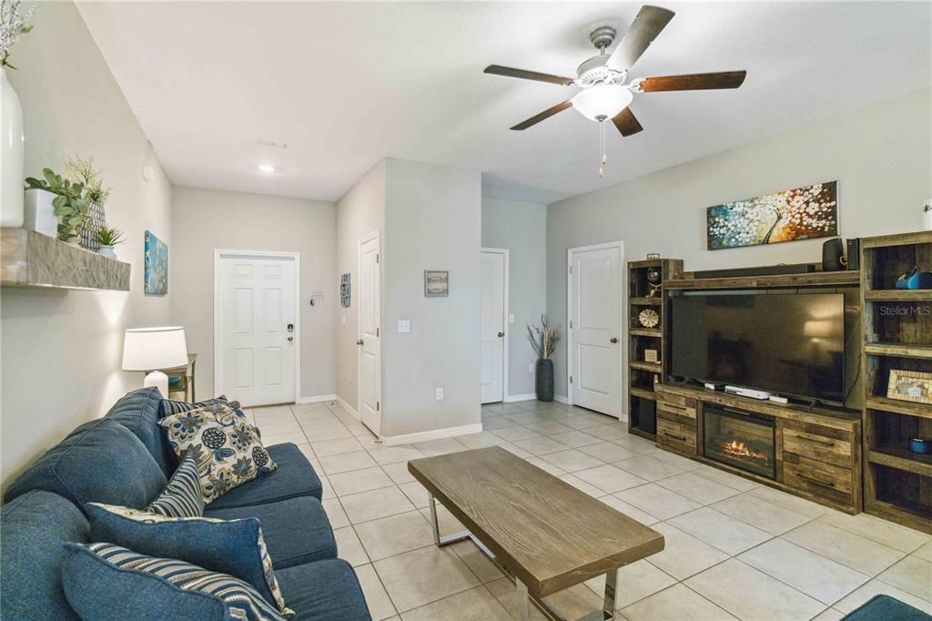 14339 Easy Goer Street Ruskin, FL 33573 - Photo 10 of 49 a living room with furniture and a flat screen tv