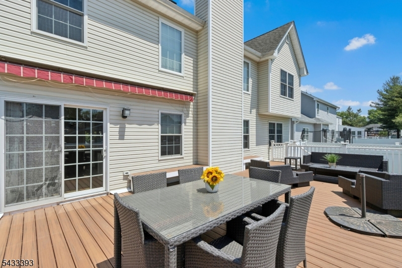 33 Stanton Street Clark, NJ 07066 - Photo 31 of 37 a view of a deck with table and chairs and wooden floor