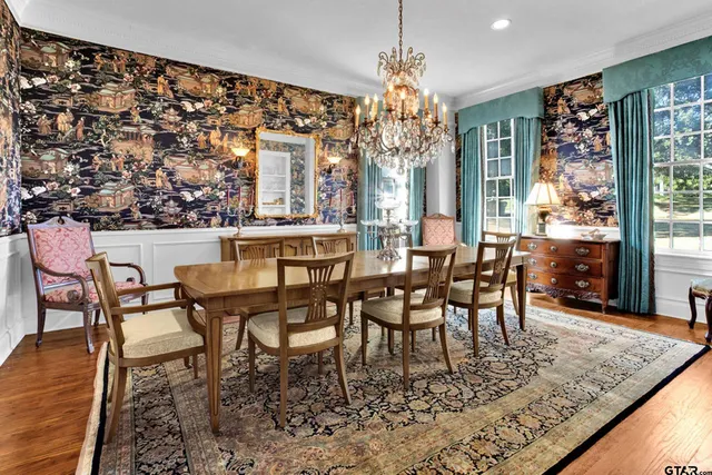 a view of a dining room with furniture and chandelier