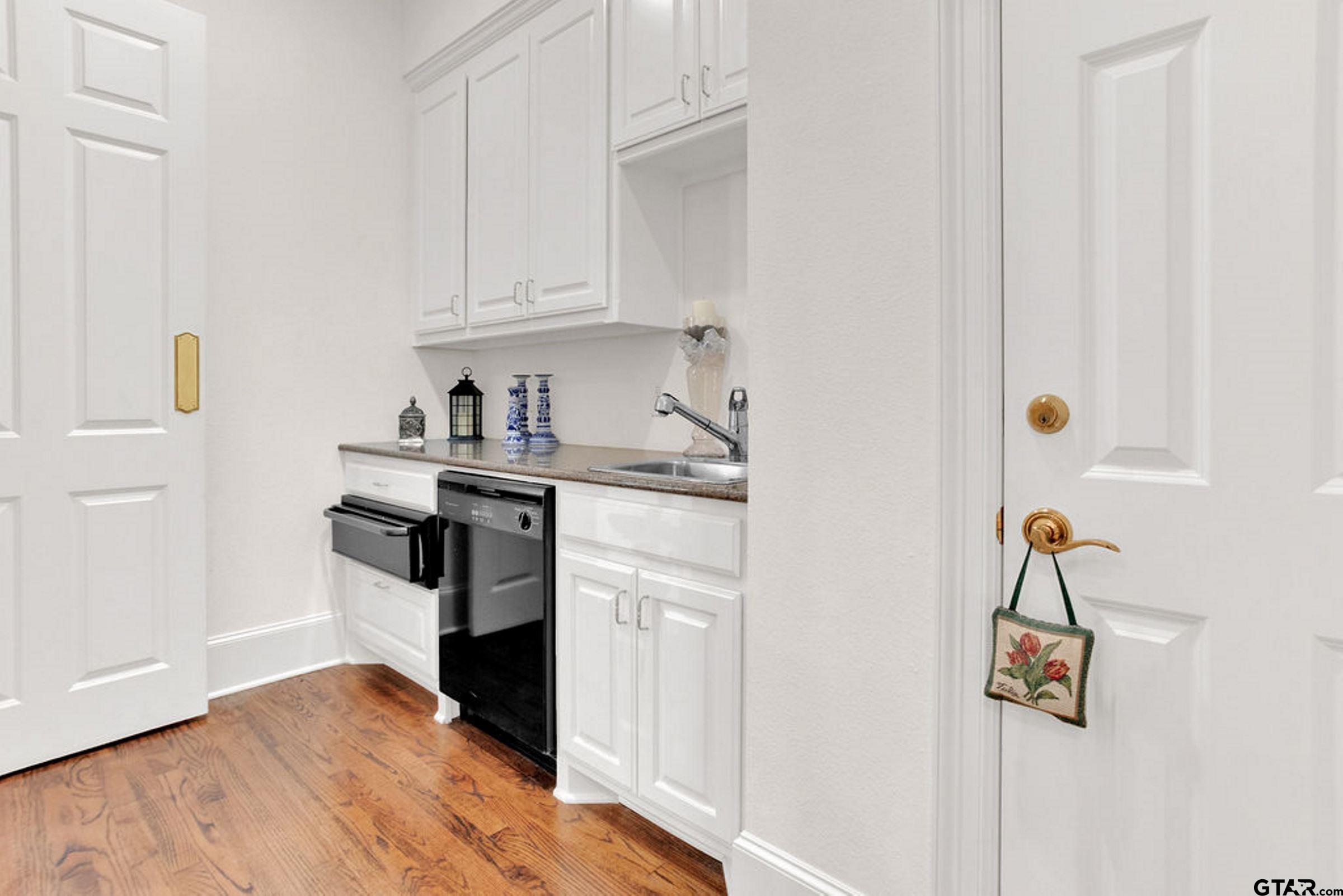 408 East Jolly Street Palestine, TX 75801 - Photo 14 of 48 a kitchen with a refrigerator and white cabinets
