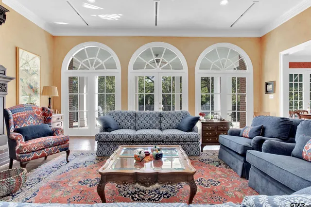 a living room with furniture fireplace and a large window
