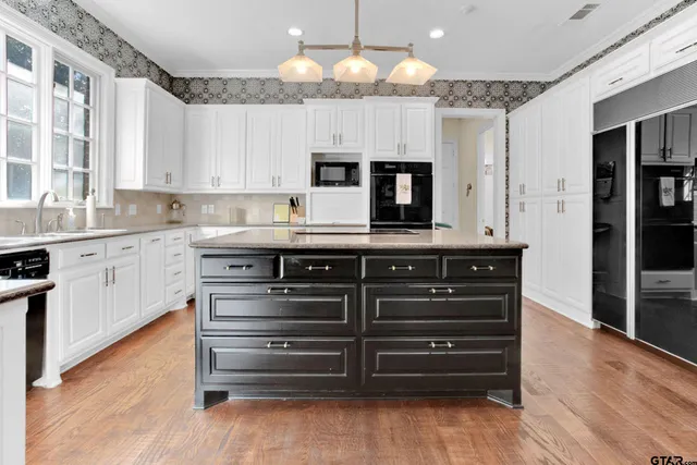 a kitchen with stainless steel appliances granite countertop a stove and a sink