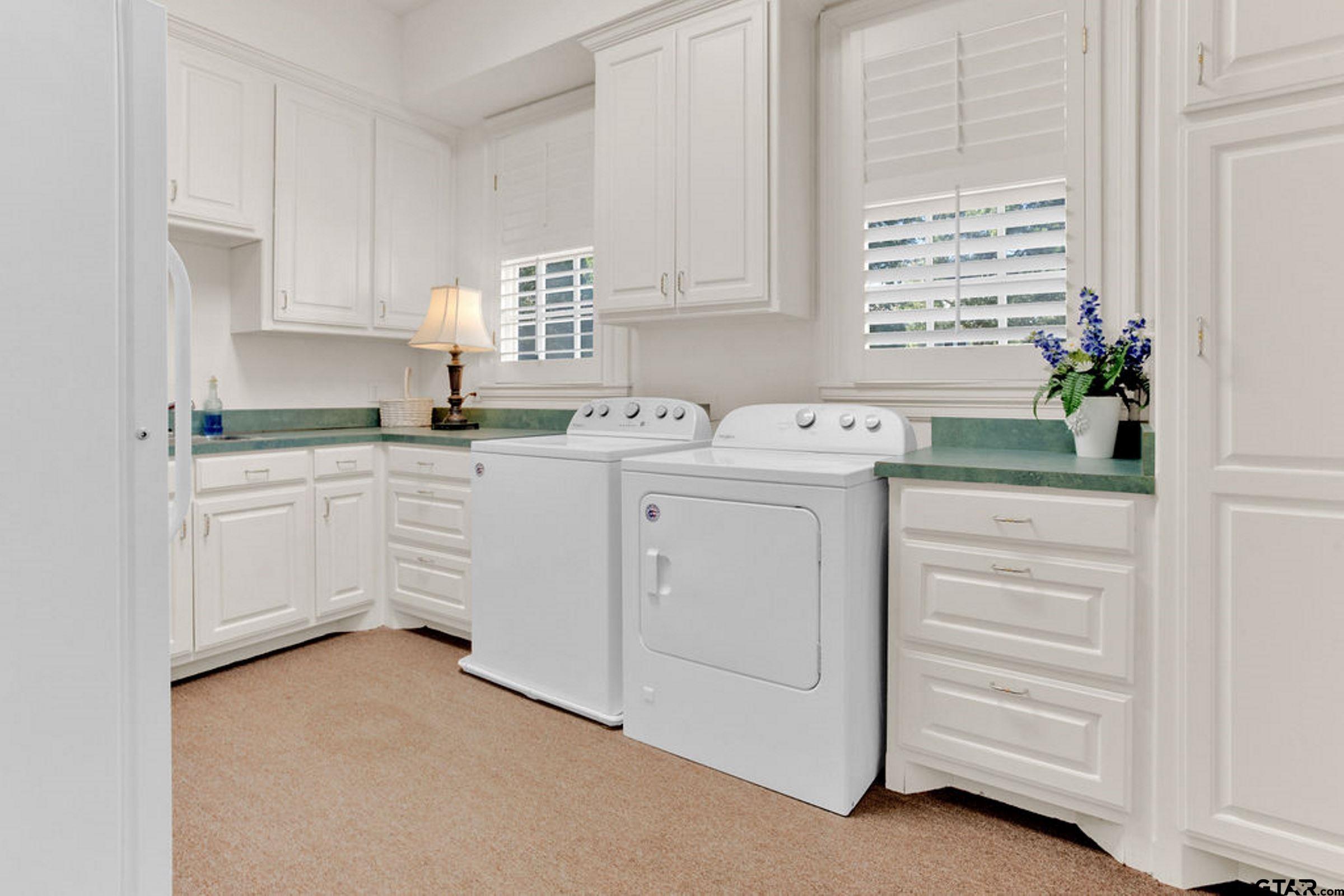 408 East Jolly Street Palestine, TX 75801 - Photo 22 of 48 a kitchen with white cabinets and sink