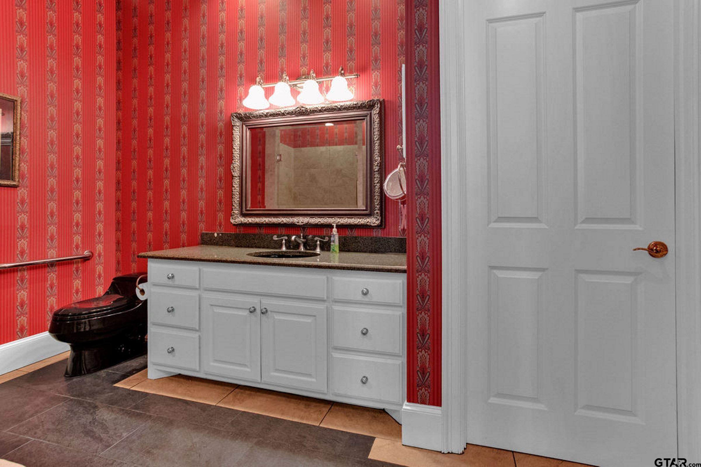 408 East Jolly Street Palestine, TX 75801 - Photo 28 of 48 a bathroom with a sink and a mirror