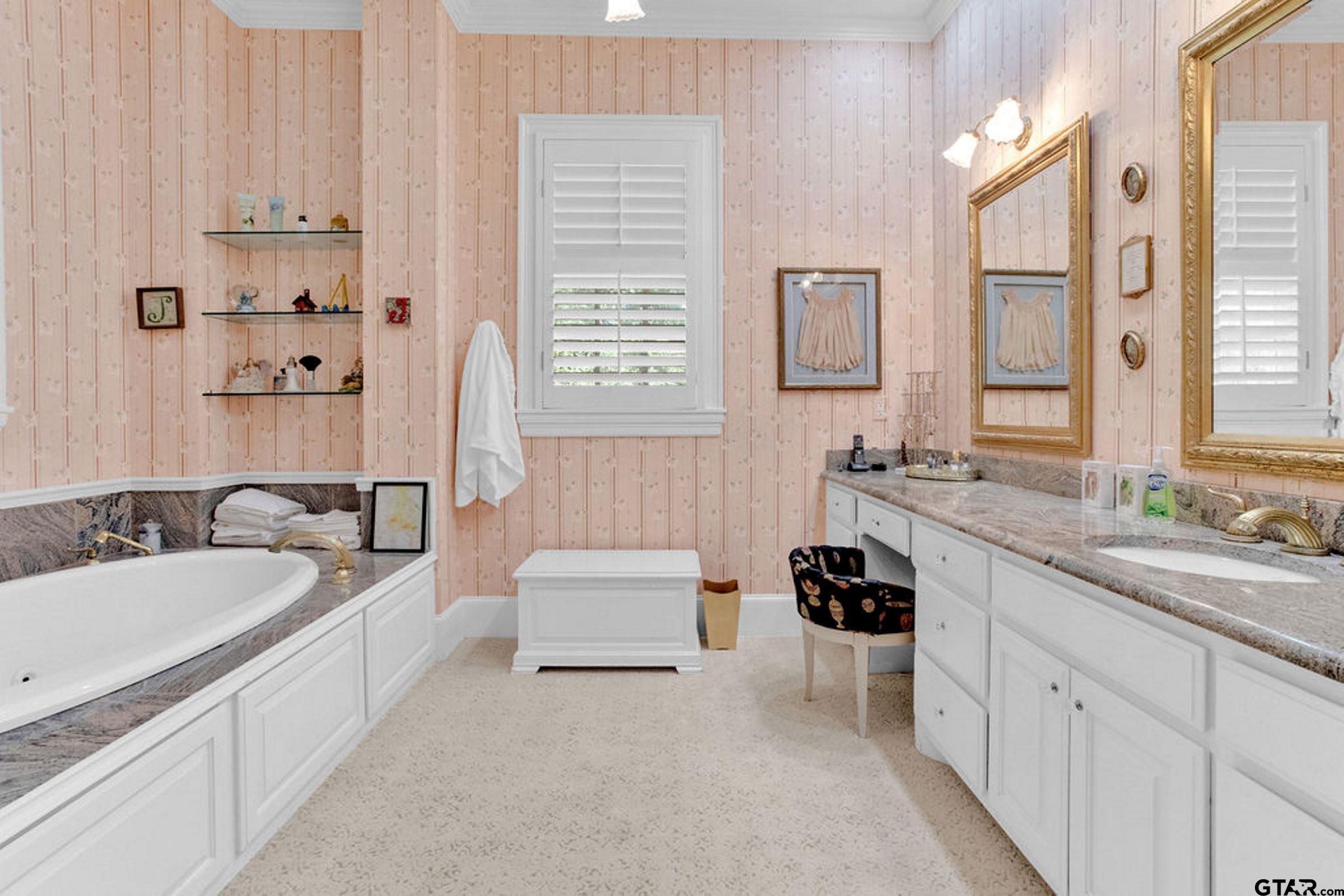 408 East Jolly Street Palestine, TX 75801 - Photo 29 of 48 a spacious bathroom with a double vanity sink a mirror a bathtub and next to a window