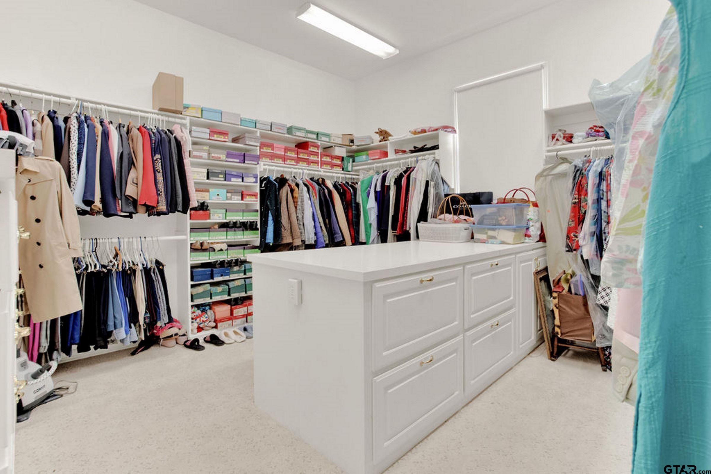 408 East Jolly Street Palestine, TX 75801 - Photo 31 of 48 a view of walk in closet with clothes and shoes