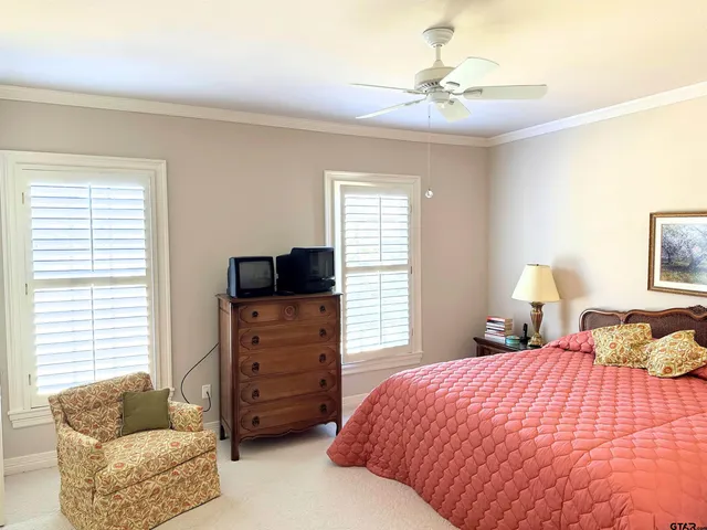 a bedroom with furniture and a chandelier