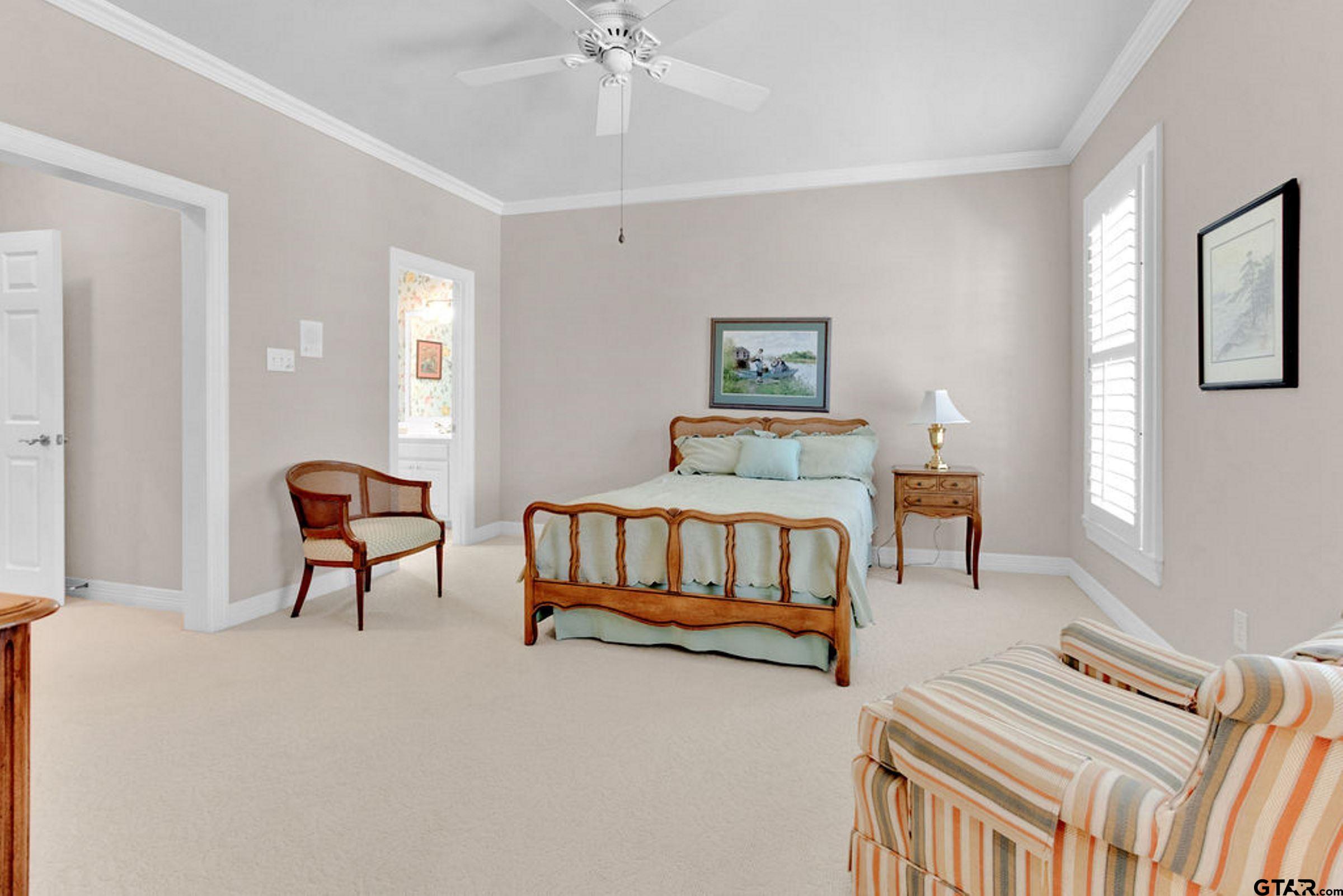 408 East Jolly Street Palestine, TX 75801 - Photo 36 of 48 a bedroom with furniture and a chandelier