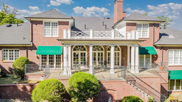 a aerial view of a house with a yard and large trees