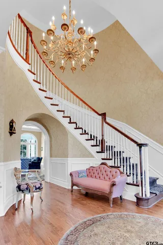 a view of entryway and hall with wooden floor