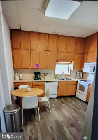 a view of a kitchen with furniture and wooden floor