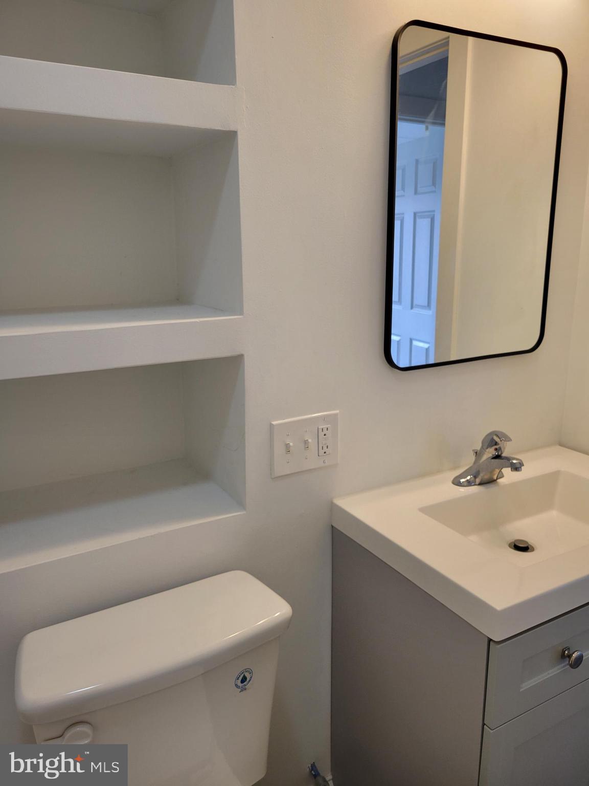 1801 South Main Street, Unit 6 Bechtelsville, PA 19505 - Photo 19 of 20 a bathroom with a toilet sink and mirror