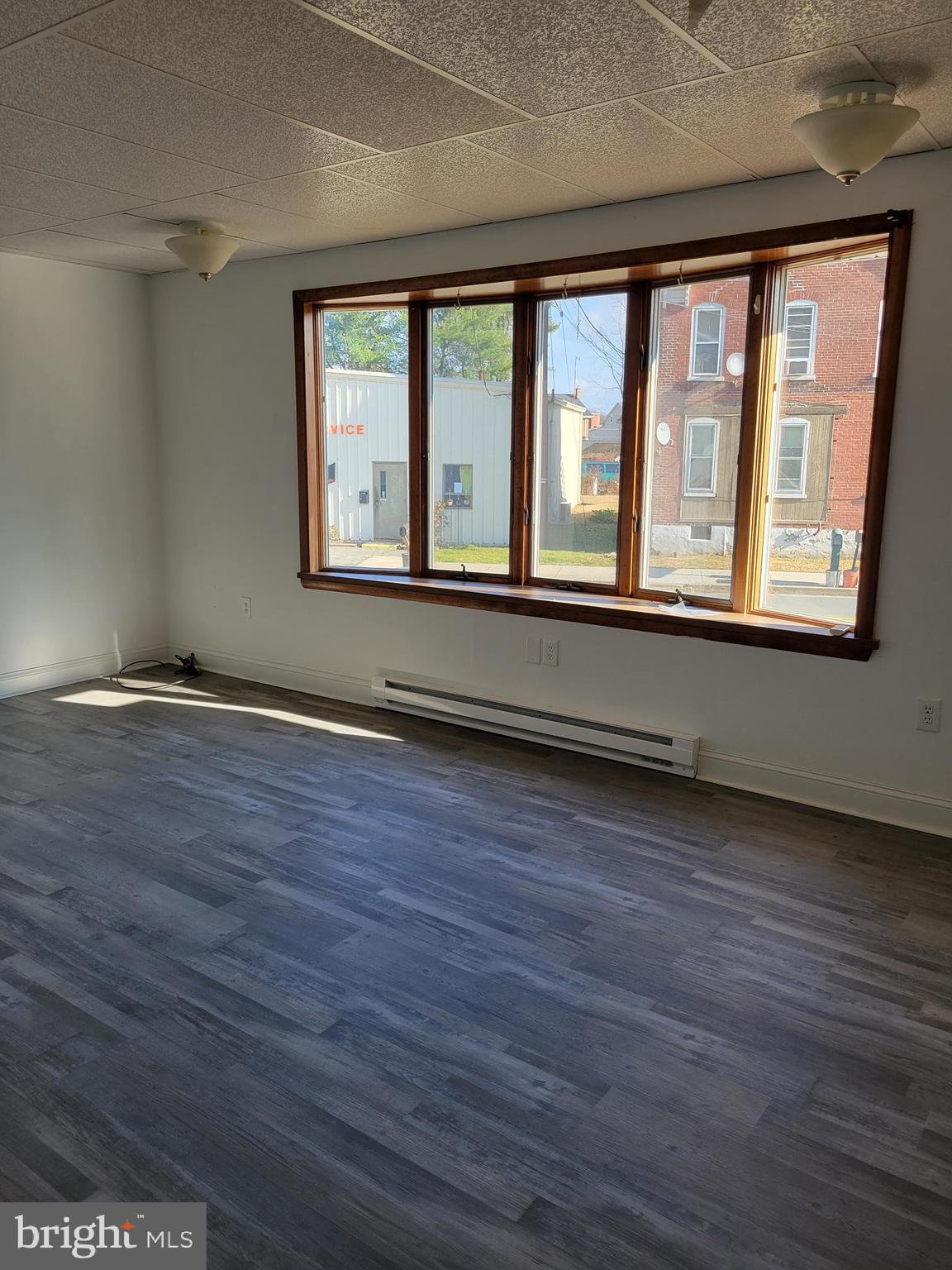 1801 South Main Street, Unit 6 Bechtelsville, PA 19505 - Photo 6 of 20 an empty room with wooden floor and windows