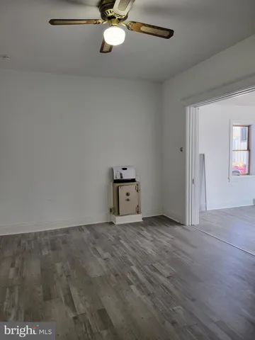 a view of a room with wooden floor