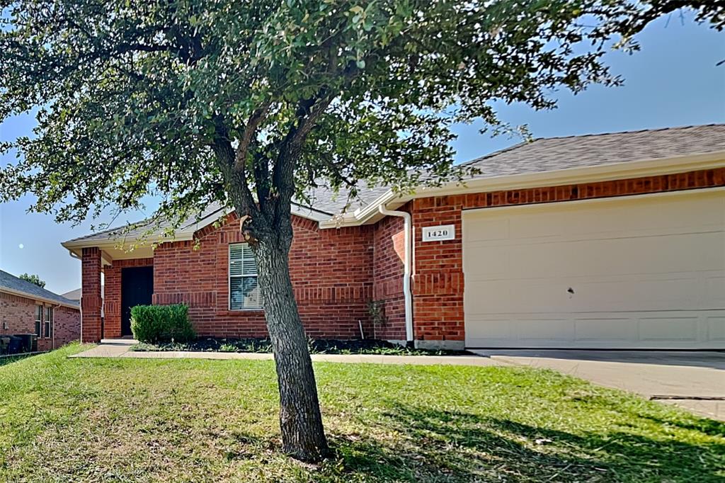 1420 Waterford Drive Little Elm, TX 75068 - Photo 1 of 23 a house with a tree in front of it