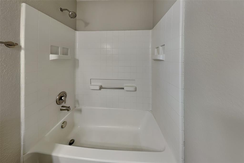1420 Waterford Drive Little Elm, TX 75068 - Photo 12 of 23 a white bath tub sitting next to a white sink and vanity