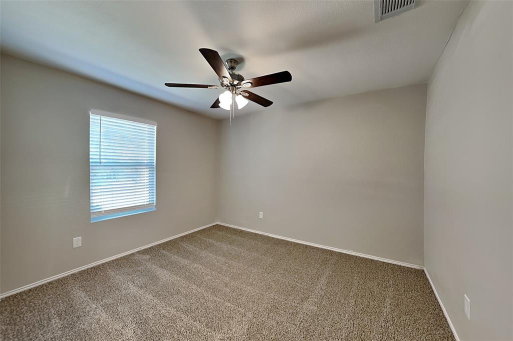 1420 Waterford Drive Little Elm, TX 75068 - Photo 14 of 23 an empty room with a window and a fan
