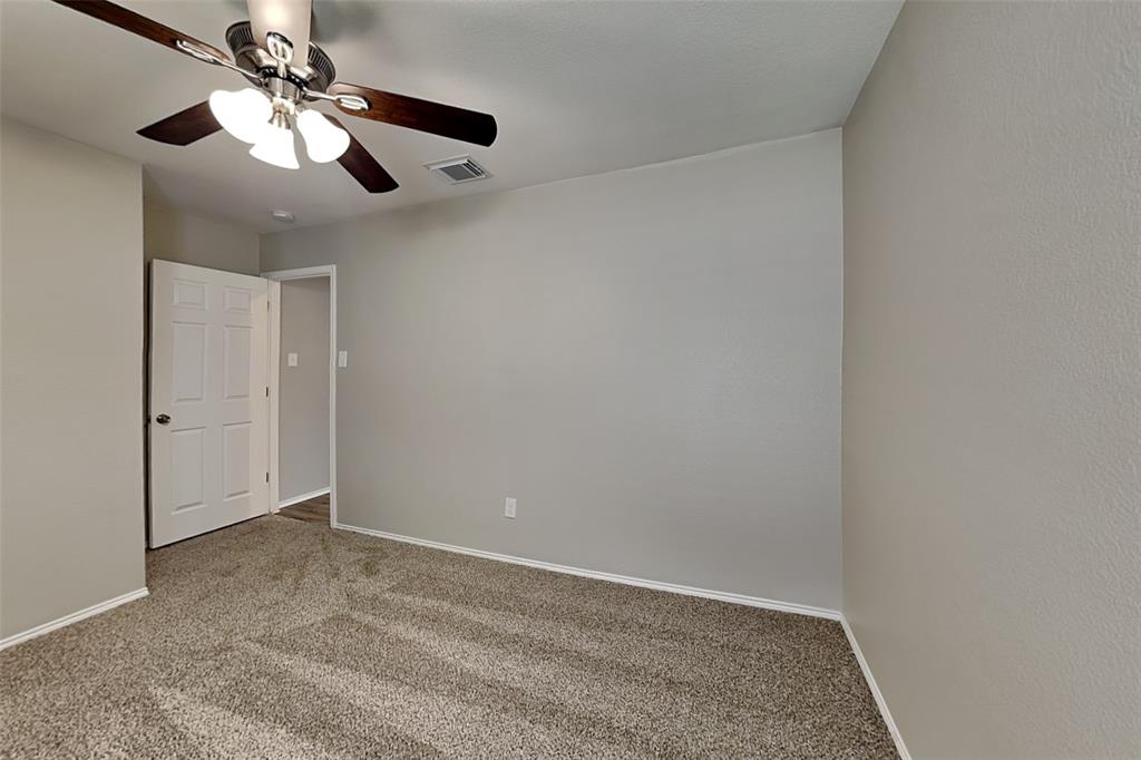 1420 Waterford Drive Little Elm, TX 75068 - Photo 18 of 23 an empty room with a chandelier fan and closet