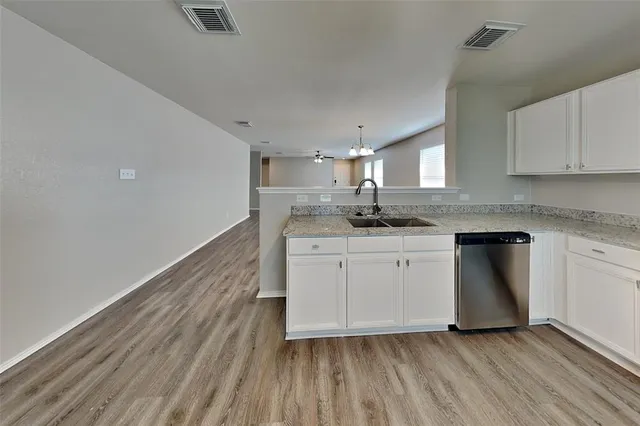 a kitchen with a sink window and cabinets