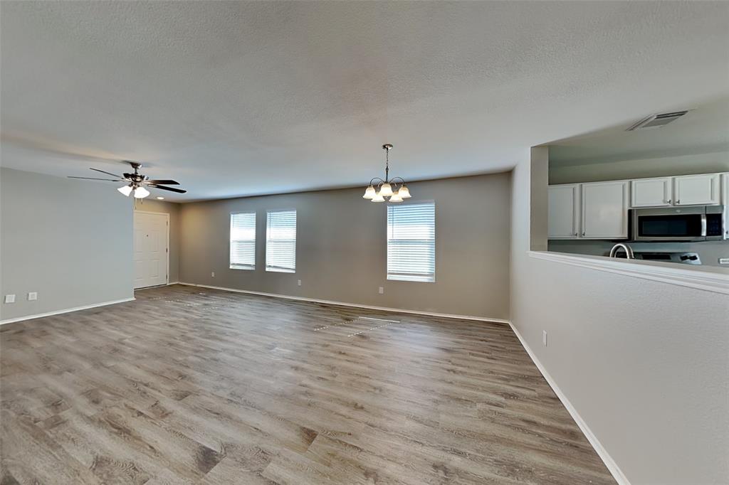 1420 Waterford Drive Little Elm, TX 75068 - Photo 7 of 23 a view of empty room with wooden floor and fan