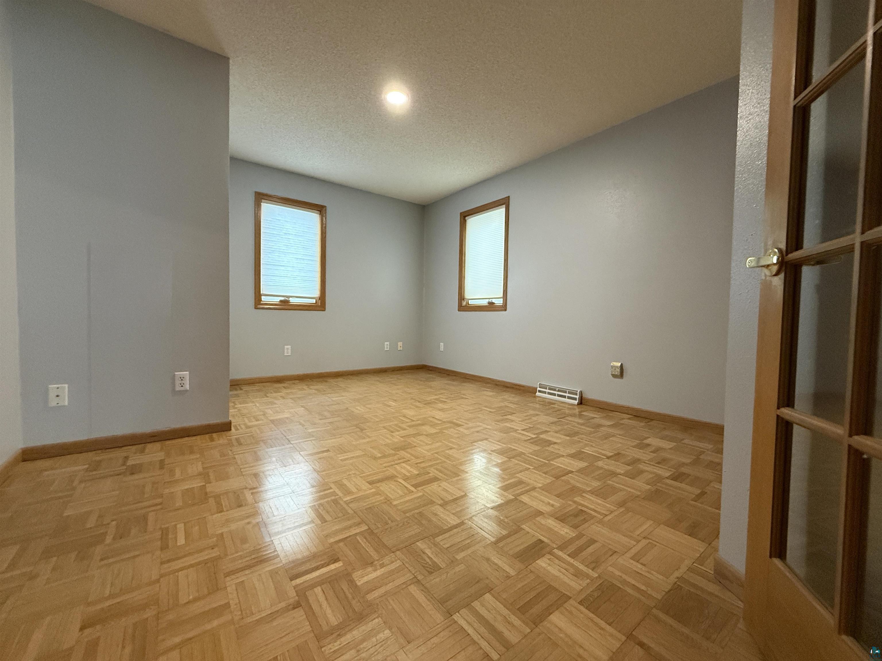 1321 South 13th Street Virginia, MN 55792 - Photo 15 of 33 Spare room featuring parquet floors and a textured ceiling