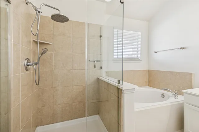 a bathroom with a sink a window and a shower