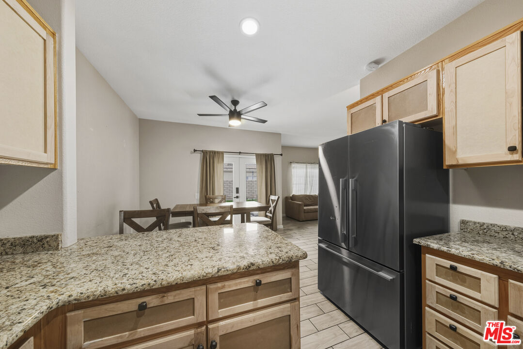 47395 Monroe Street, Unit 254 Indio, CA 92201 - Photo 11 of 21 a kitchen with granite countertop a refrigerator and a sink
