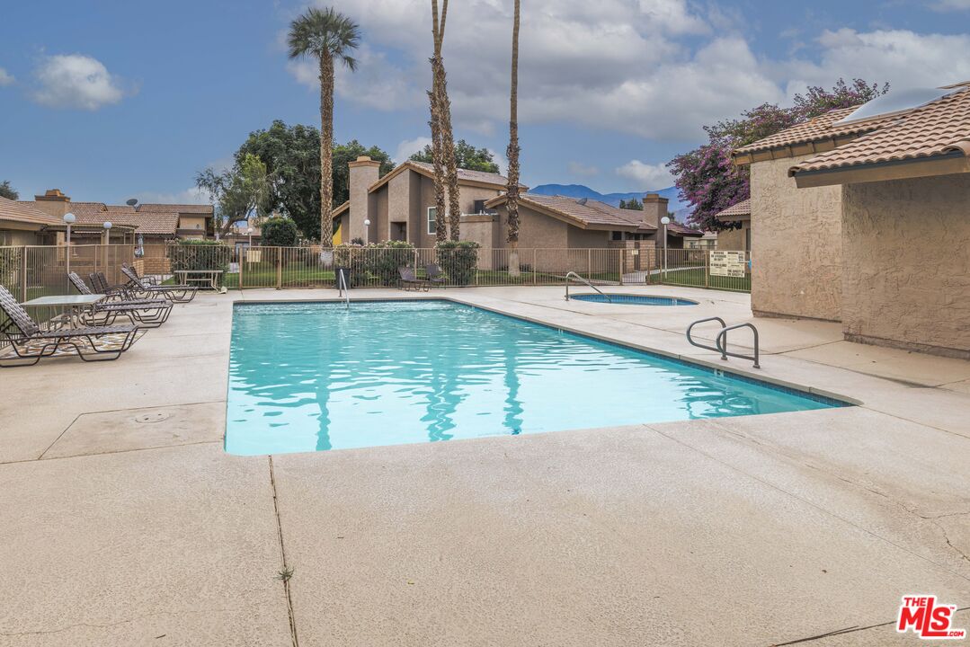 47395 Monroe Street, Unit 254 Indio, CA 92201 - Photo 21 of 21 a view of a swimming pool with a lawn chairs
