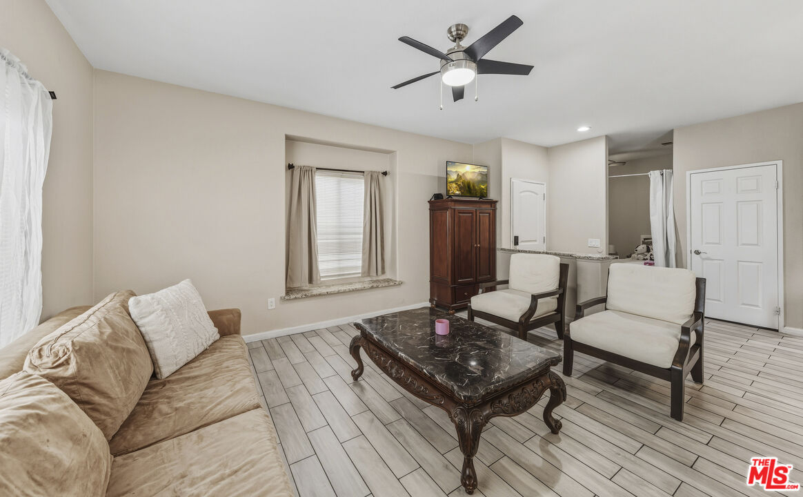 47395 Monroe Street, Unit 254 Indio, CA 92201 - Photo 6 of 21 a living room with furniture and a wooden floor