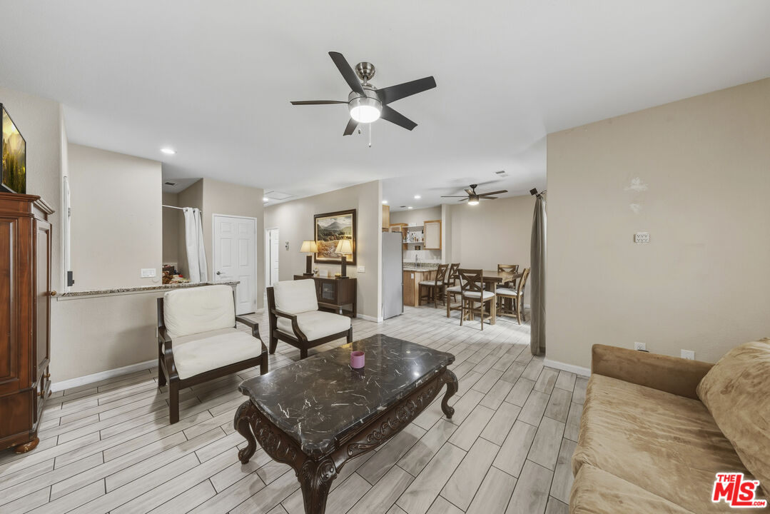 47395 Monroe Street, Unit 254 Indio, CA 92201 - Photo 7 of 21 a living room with furniture and a wooden floor