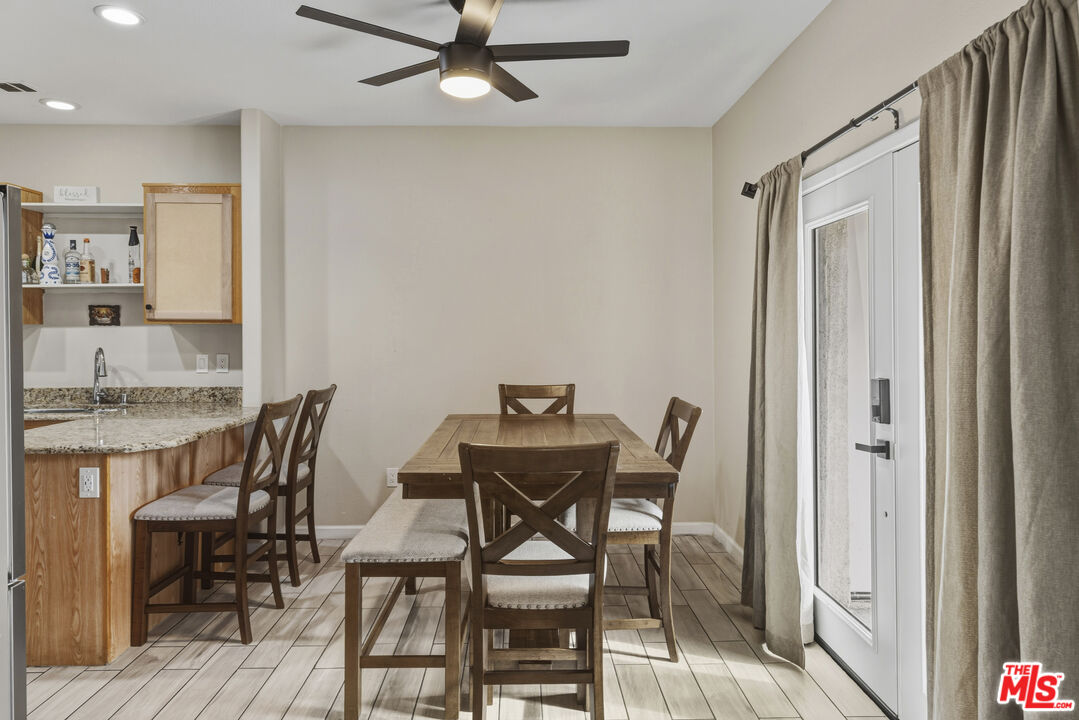 47395 Monroe Street, Unit 254 Indio, CA 92201 - Photo 8 of 21 a view of a dining room with furniture and wooden floor