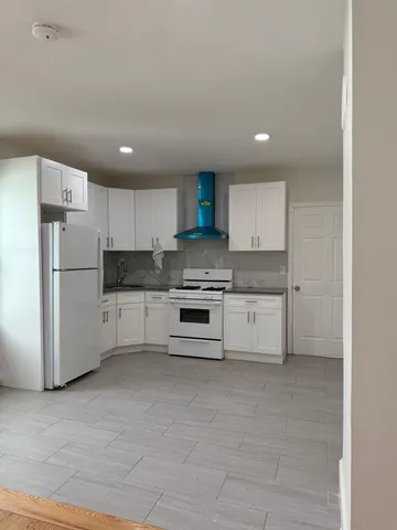 a kitchen with stainless steel appliances a refrigerator sink and cabinets