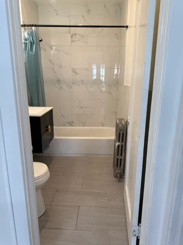 a bathroom with a shower and a toilet