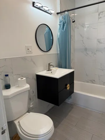 a bathroom with a sink a toilet and a mirror