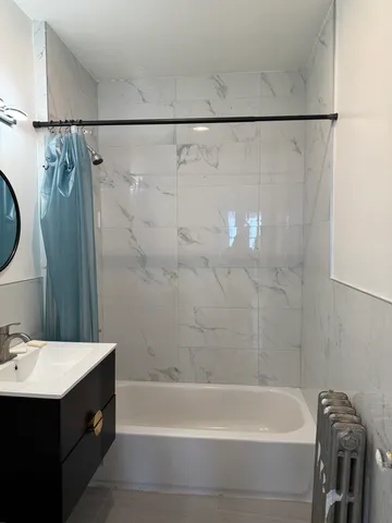 a bathroom with a bathtub and a sink