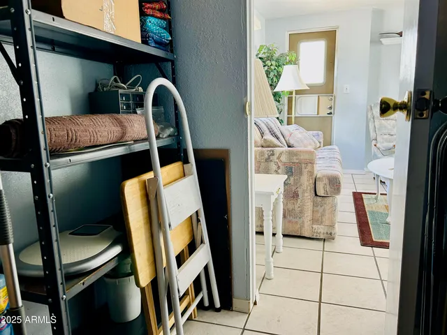 a view of living room with furniture and a mirror