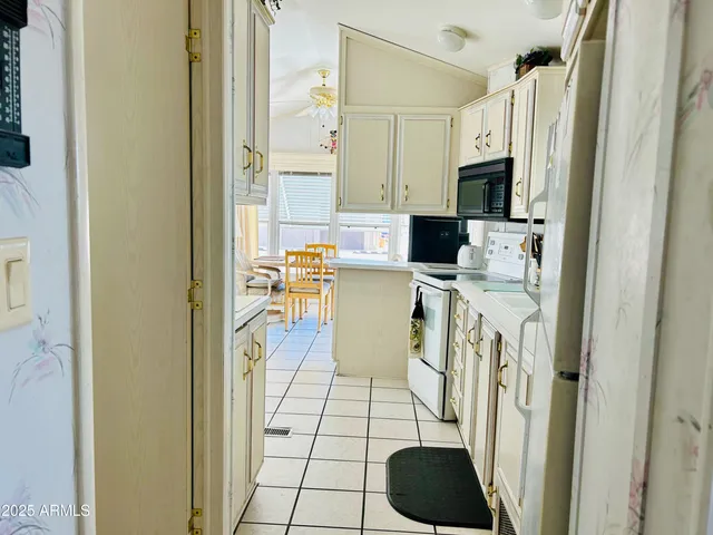 a kitchen with stainless steel appliances a refrigerator a stove a microwave a sink and dishwasher