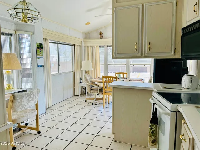 a kitchen with a sink cabinets and window