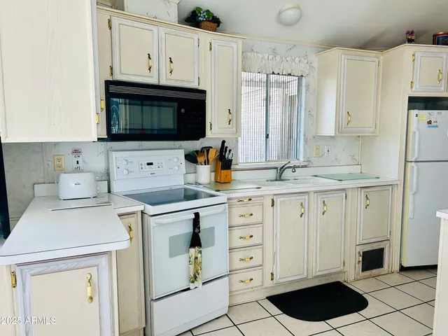 a kitchen with cabinets stainless steel appliances and a sink