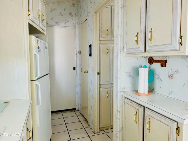 a kitchen with stainless steel appliances a refrigerator and cabinets