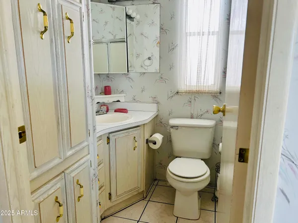 a bathroom with a toilet sink and mirror