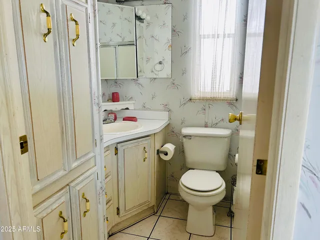 a bathroom with a toilet sink and mirror