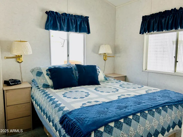 a bedroom with a bed a lamp and a window