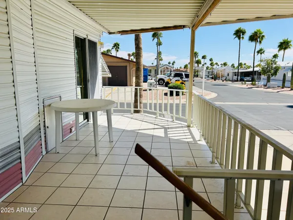 a view of a patio with a dining table and chairs