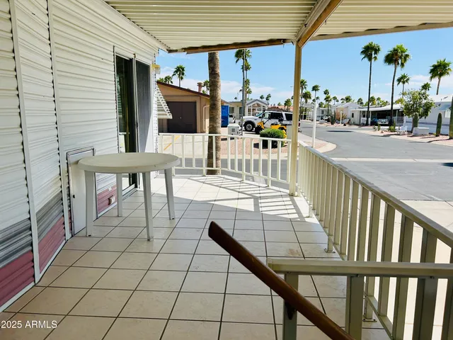 a view of a patio with a dining table and chairs