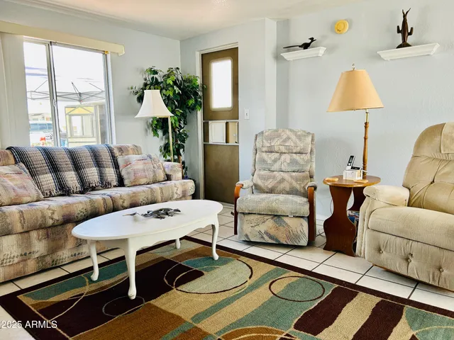 a living room with furniture and a lamp