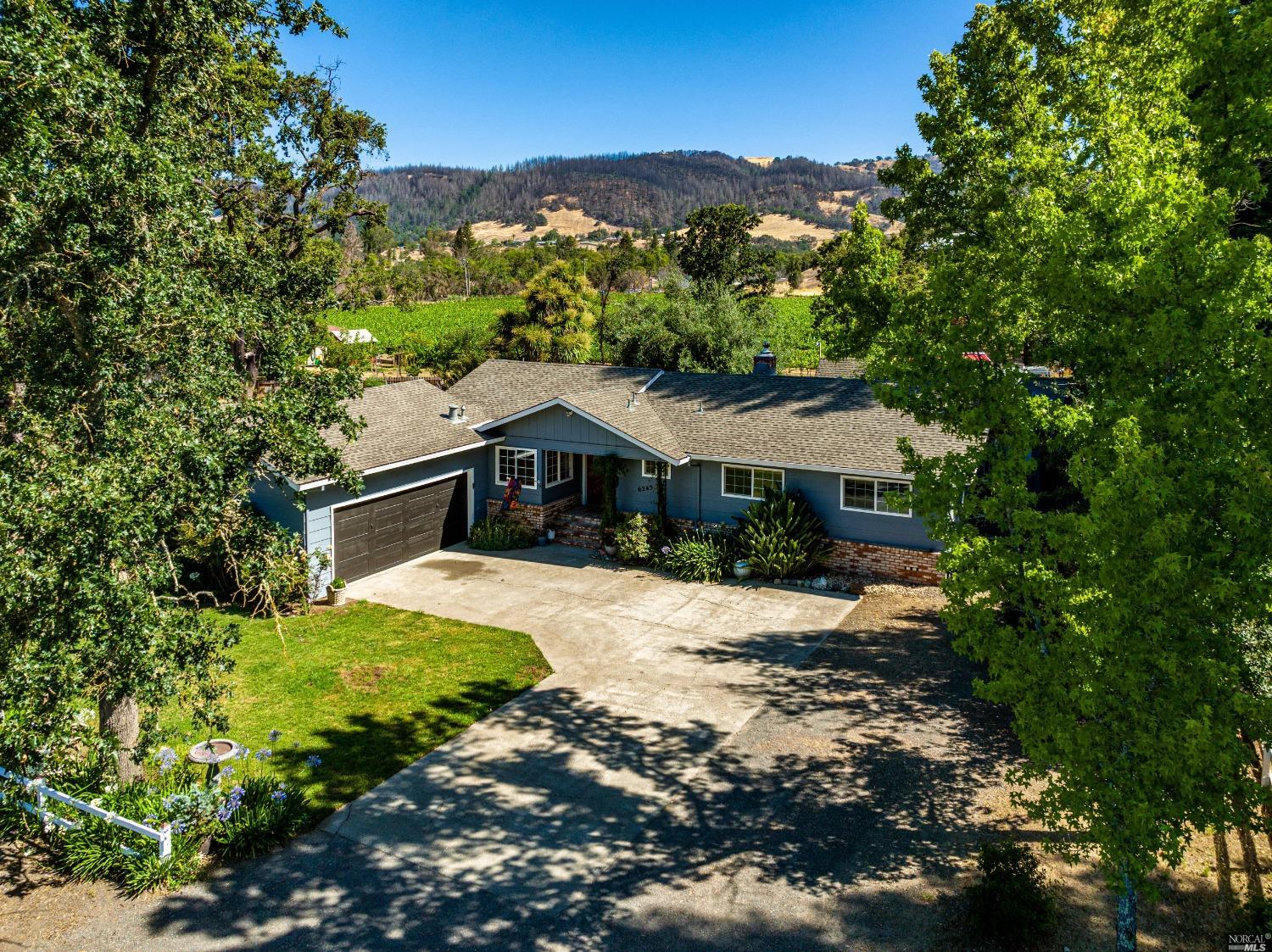 6245 Melita Road Santa Rosa, CA 95409 - Photo 1 of 1 a house with trees in the background